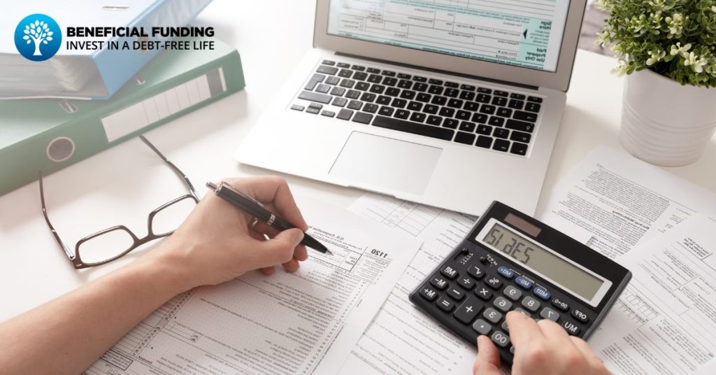 person-using-calculator-while-filing-taxes